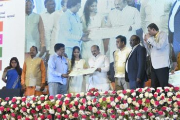 CM distributes the cheque to beneficiaries;Building a better society is possible if work earns respect:CM Bommai